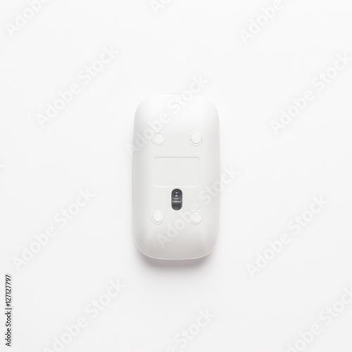 wireless computer mouse upside down on white background. not isolated