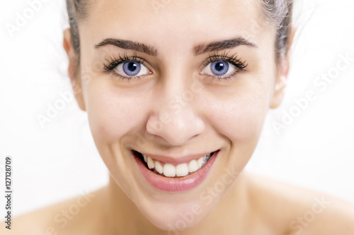 Beautiful happy young woman with deep blue color of eyes