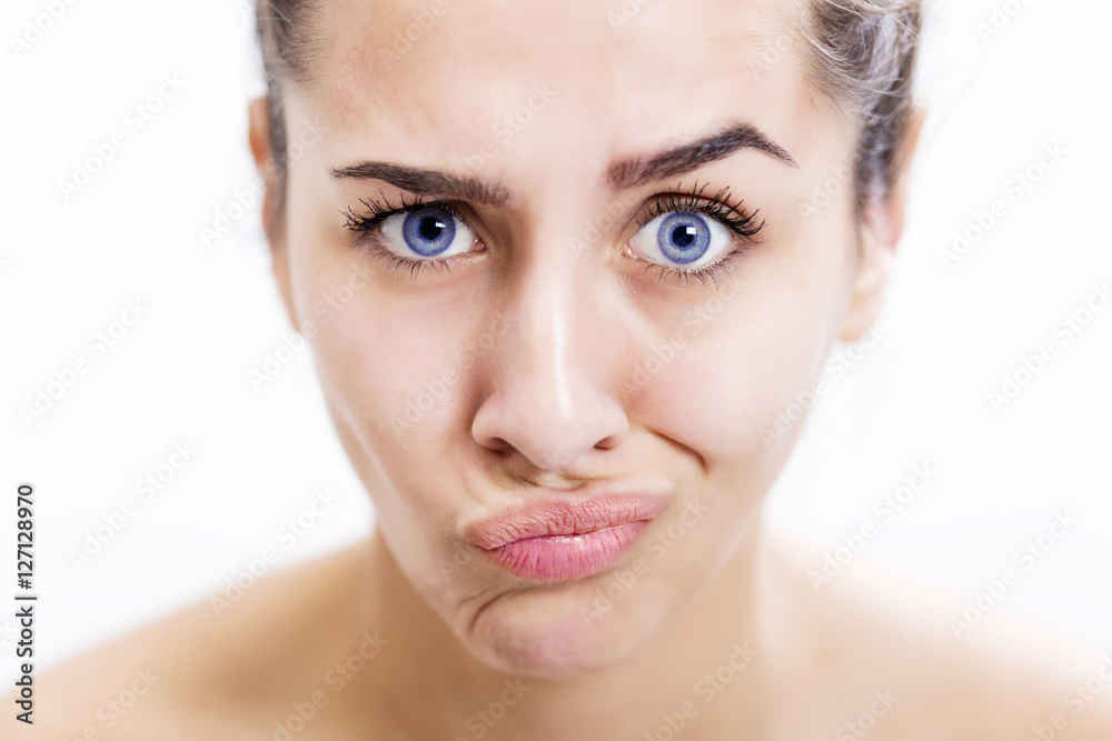Face of a serious young woman with beautiful color of eyes Face of a serious young woman with beautiful color of eyes