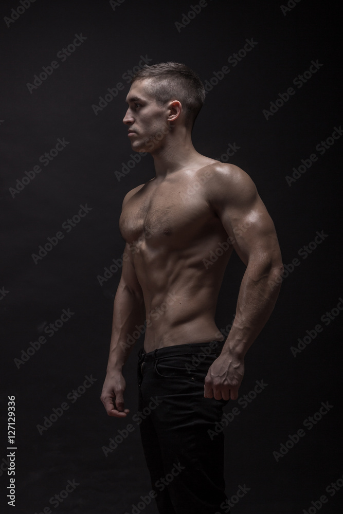 young man, bodybuilder posing, side view, profile