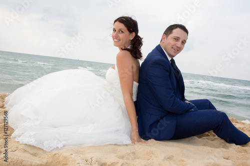 Couple in wedding dress back to back
