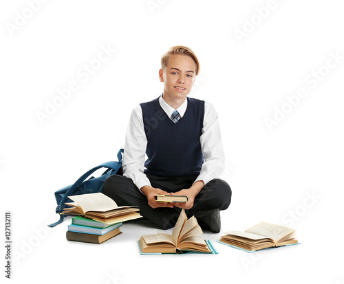 Cute teenager with textbook...