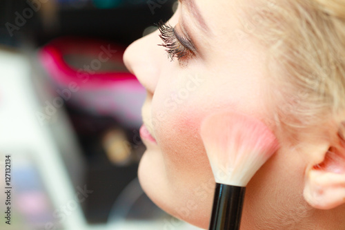 Close up woman getting make up, blush photo