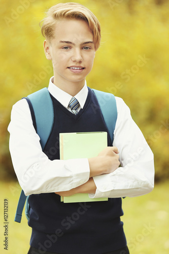Handsome teenager with book...