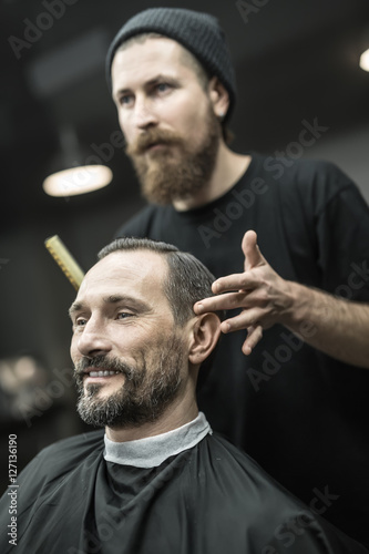 Making hairstyle in barbershop