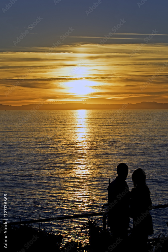 Sunset couple silhouette at Laguna Beach, California