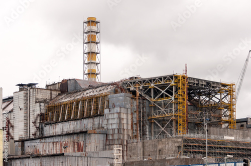 Chernobyl nuclear power plant. View on old destroyed sarcophagus before cover station of new safety confinement. Pripyat abondoned zone, Ukraine