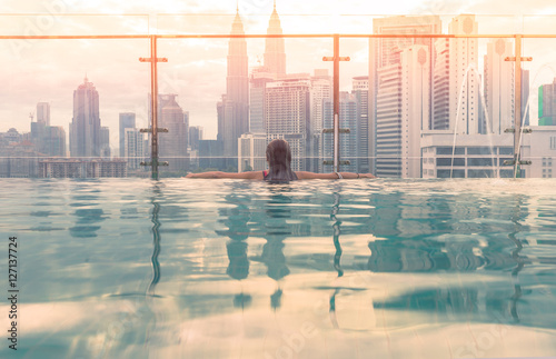 Kuala Lumpur, Malaysia city skyline at sunrise. Swimming pool on roof top with beautiful city view kuala lumpur malaysia.