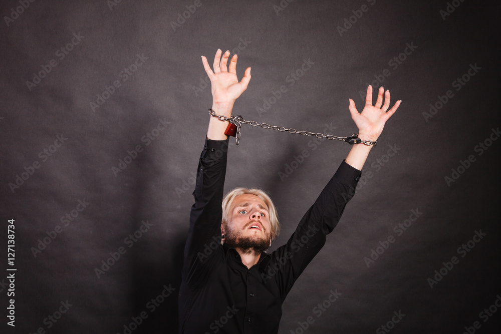 Furious man with chained hands, no freedom Furious man with chained hands, no freedom