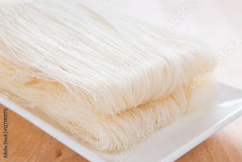 Close-up of white rice noodles on a white plate. rice vermicelli