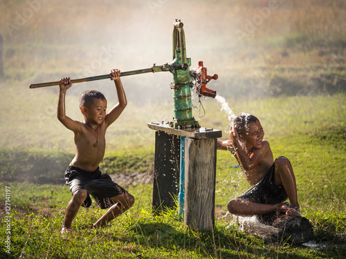 Two young boy rocking groundwater bathe in the hot days, Country