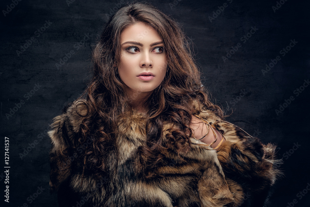 Brunette female dressed in a fur jacket. Brunette female dressed in a fur jacket.