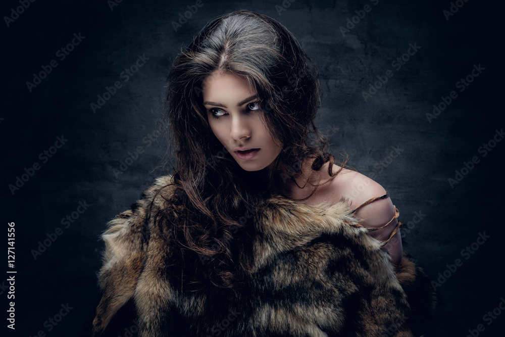 Brunette female dressed in a fur jacket. Brunette female dressed in a fur jacket.