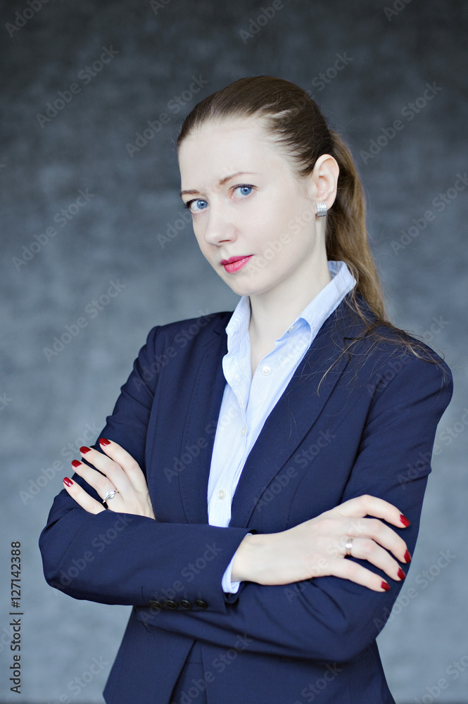 Business portrait of young woman on textured gray background. Business portrait of young woman on textured gray background.