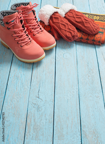 winter clothes and shoes on a wooden background