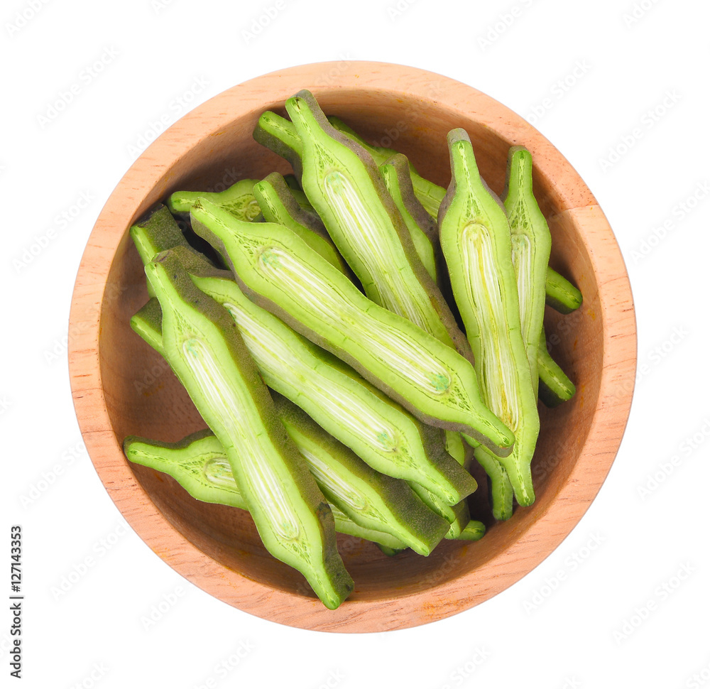 top view of slice Oroxylum indicum in wooden bowl isolated on wh top view of slice Oroxylum indicum in wooden bowl isolated on wh