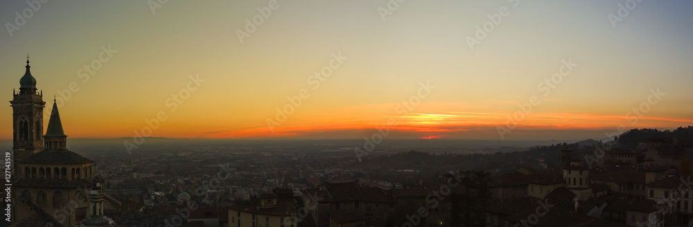Bergamo - Old city (Citta Alta). One of the beautiful city in Italy. Lombardia. Evening sunset. Landscape on the old city, Cathedral, clock towers and the Po Valley.          