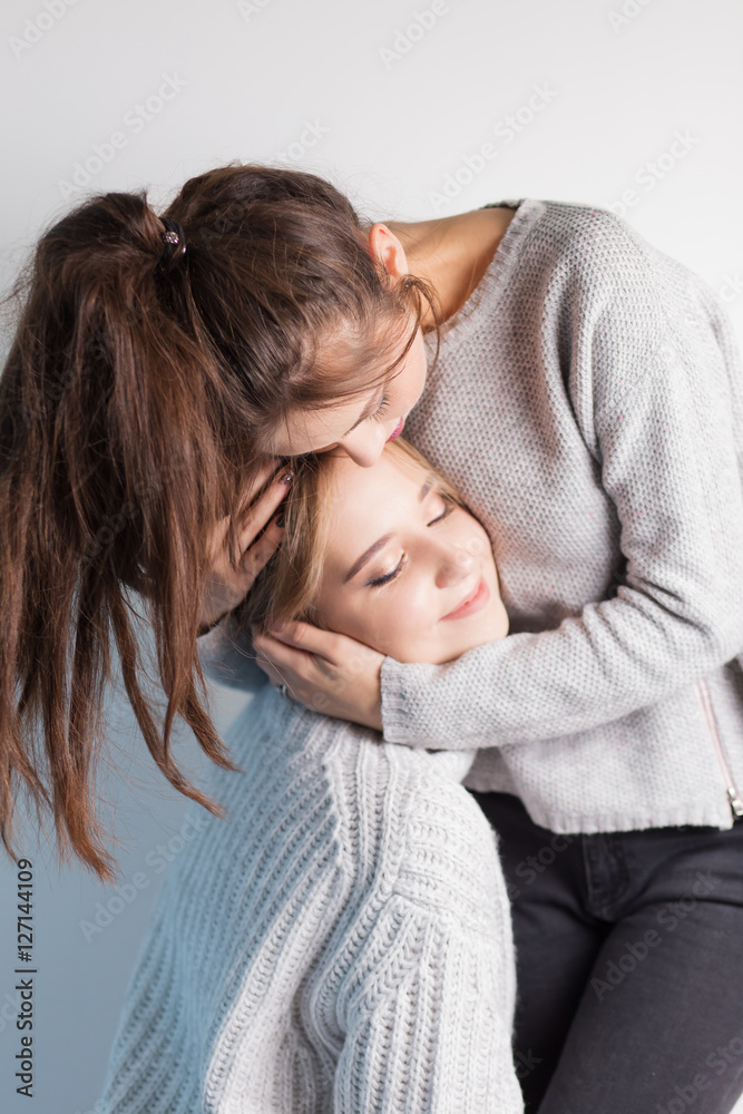 two female friends hugging two female friends hugging