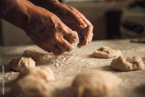 Fototapeta Naklejka Na Ścianę i Meble -  homemade cakes of the dough in the women's hands