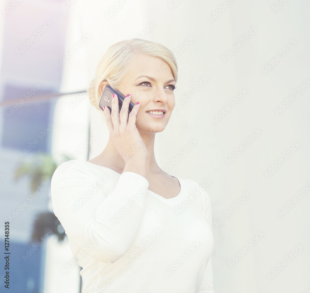 Young blond businesswoman with a tablet outdoors Young blond businesswoman with a tablet outdoors