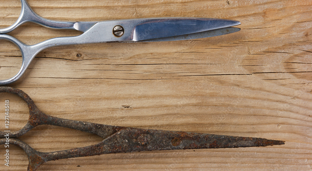 old tailor scissors on the wooden background old tailor scissors on the wooden background