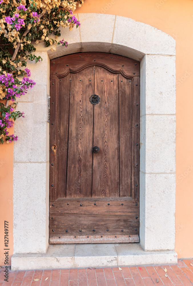 Old wooden door in the entrance stone French house