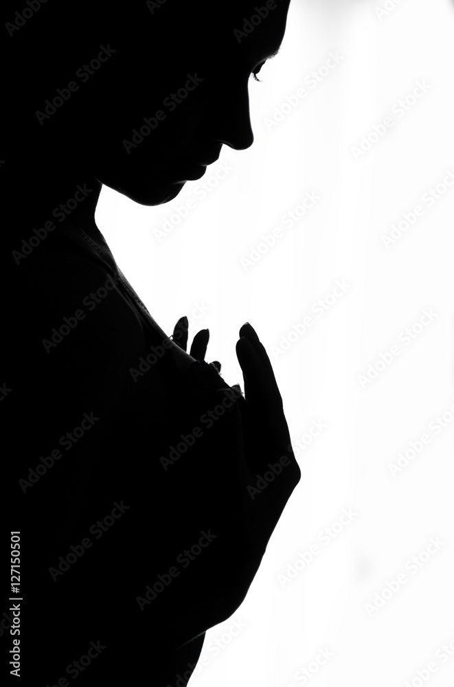 Foto de close-up silhouette of the girl holding breasts of her hands. on a  white background do Stock