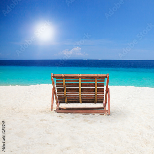 Wood chairs on the beach.