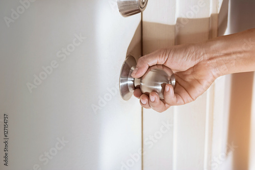 woman hand holding a doorknob photo