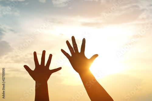  silhouette hands mother and son on sunset background