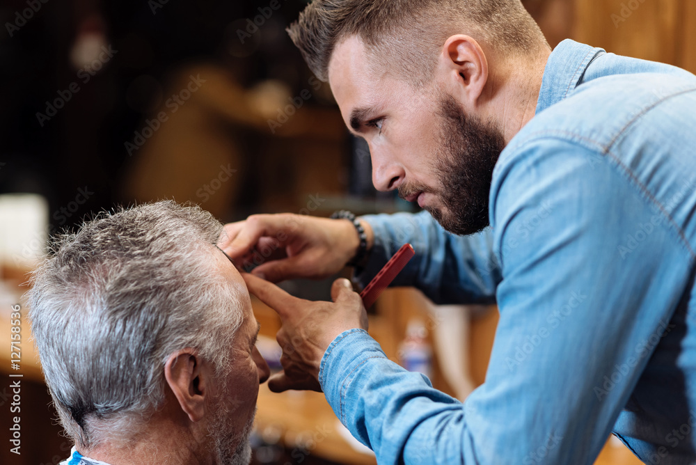 Hair dresser cutting bang of senior man Hair dresser cutting bang of senior man
