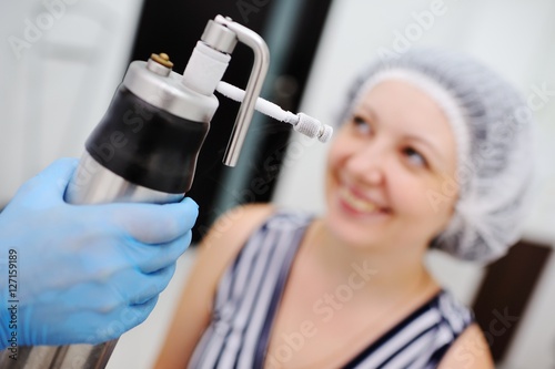 Doctor makes the patient Cryomassage photo