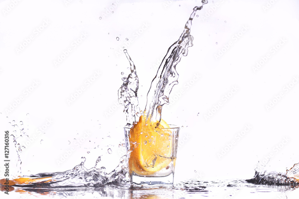 oranges splashing into martini glass oranges splashing into martini glass
