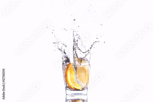 oranges splashing into martini glass