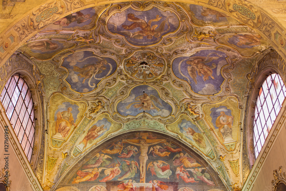 BRESCIA, ITALY - MAY 22, 2016: The ceiling baroque frescoes of side chapel and gothic-renaisscane fresco of Crucifixion by Andrea Bembo (1475) in church Chiesa di Santa Agata.