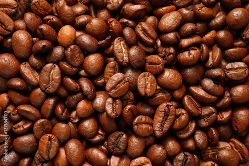 Roasted coffee beans close-up for use as a background texture.