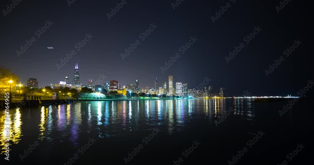 Chicago, Illinois, USA - view from the Lakefront Trail at the Field Museum / Shedd Aquarium facing north at shore of Lake Michigan and the skyline at night - Timelapse without motion Chicago, Illinois, USA - view from the Lakefront Trail at the Field Museum / Shedd Aquarium facing north at shore of Lake Michigan and the skyline at night - Timelapse without motion