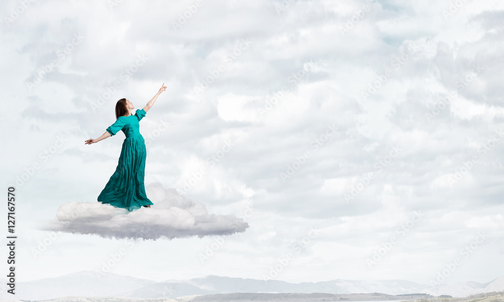 Woman levitating in sky . Mixed media Woman levitating in sky . Mixed media