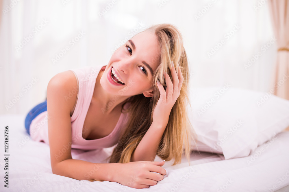 Beautiful young blonde girl in her bed with smile Beautiful young blonde girl in her bed with smile