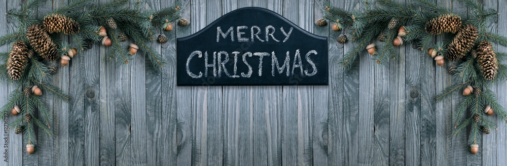 Christmas welcome signboard with spruce branches, pine cones, ac