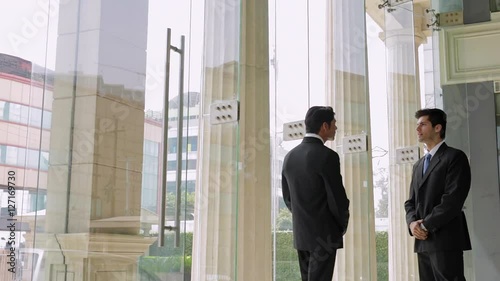 MS Businessman shaking hands in lobby / Singapore