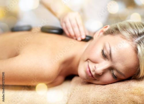 close up of woman having hot stone massage in spa