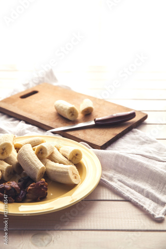 Sliced bananas and figs on a wooden table. Healthy food. Organic