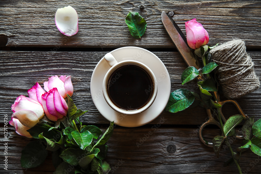 Fresh roses with diary and cup of coffee on wooden table, top view. flowers, hot drink Fresh roses with diary and cup of coffee on wooden table, top view. flowers, hot drink