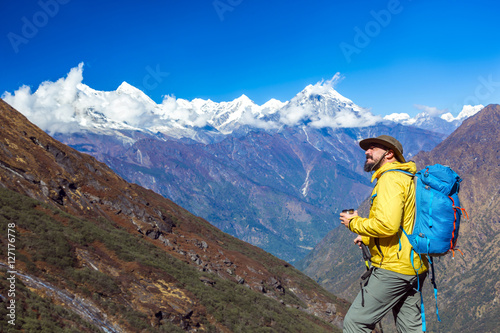 Cheerful bearded Hiker standing and looking up © alexbrylovhk