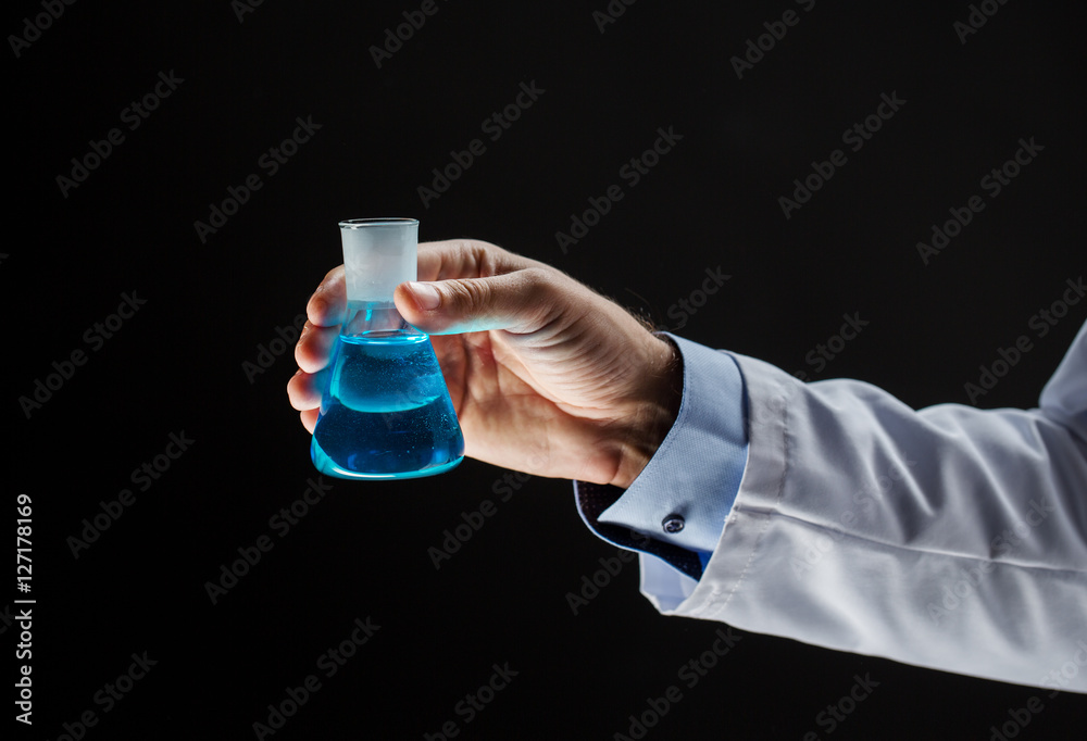 close up of scientist holding flask with chemical close up of scientist holding flask with chemical