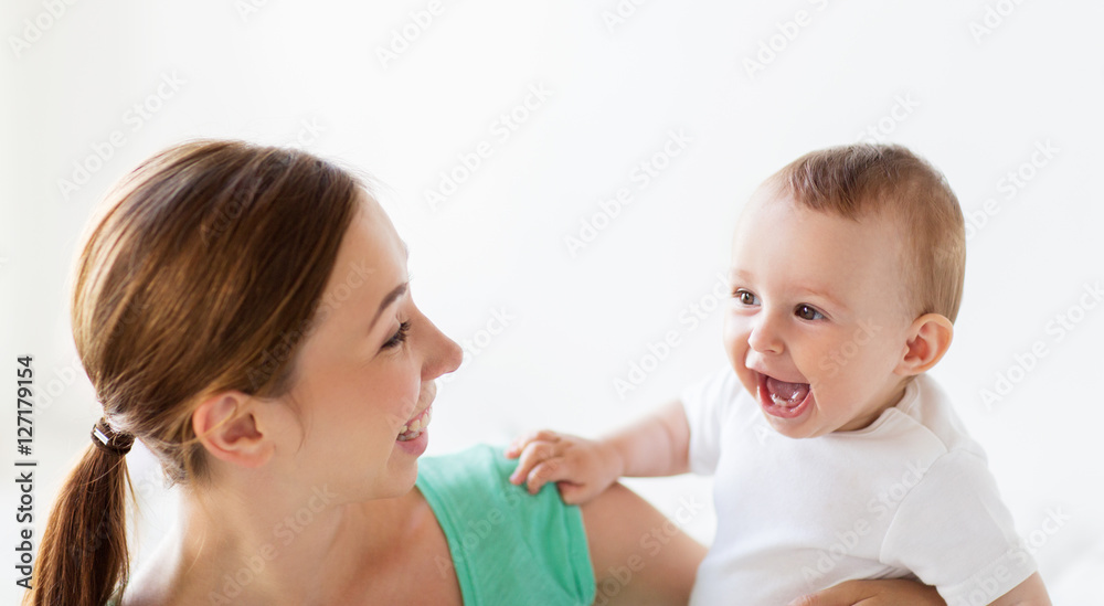 happy young mother with little baby at home