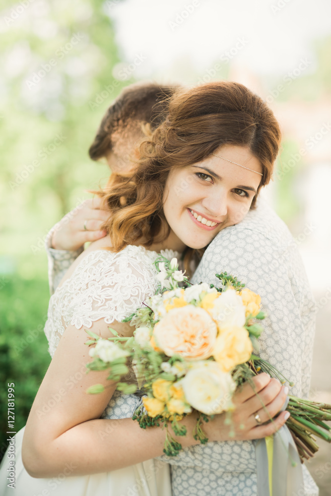 Perfect wedding couple holding luxury bouquet of flowers Perfect wedding couple holding luxury bouquet of flowers