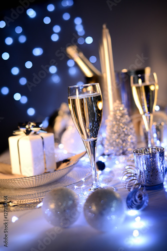 Photography dim light white silver and blue romantic new year eve or christmas table in a lu