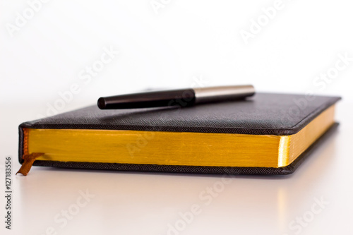 black diary with pen